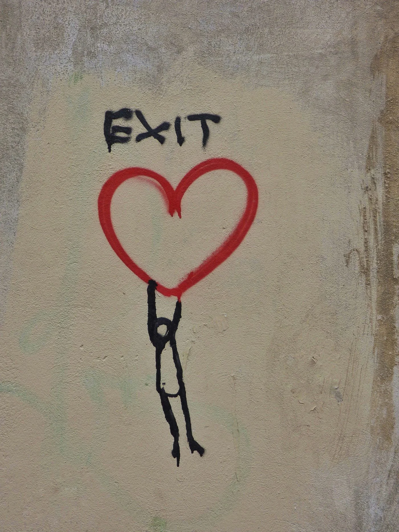 A graffiti illustration of a stick figure holding on to a heart which has the word EXIT over it