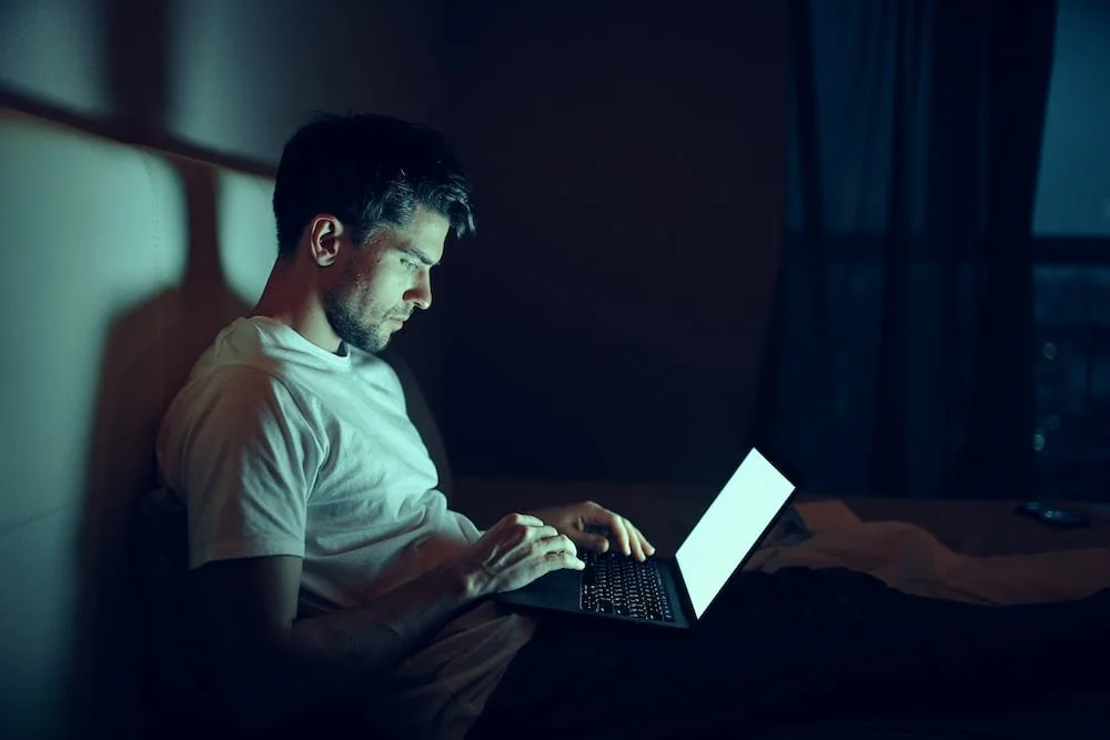 Man viewing content online alone at night
