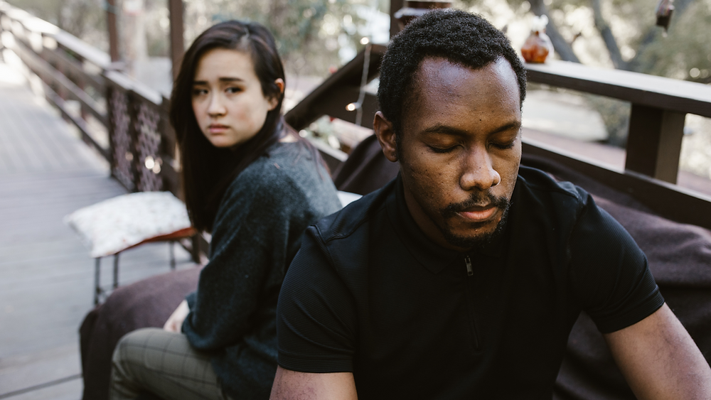 A couple sits in unhappy silence