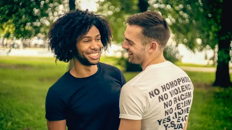 A gay couple smiling and laughing
