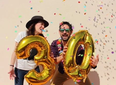 44817249-cheerful-couple-celebrates-a-thirty-years-birthday-with-big-golden-balloons-and-colorful-little.jpg