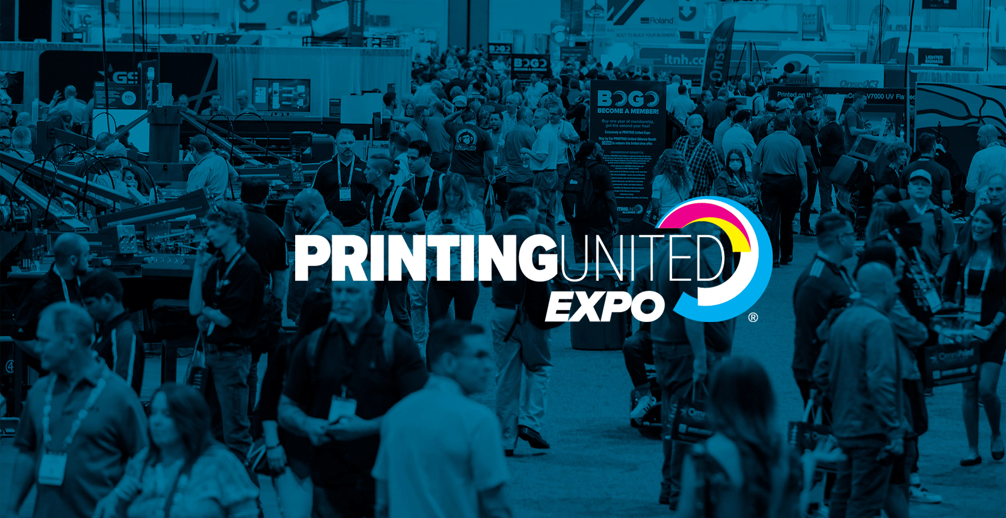 Crowd attending Printing United Expo trade show with booths and signage.