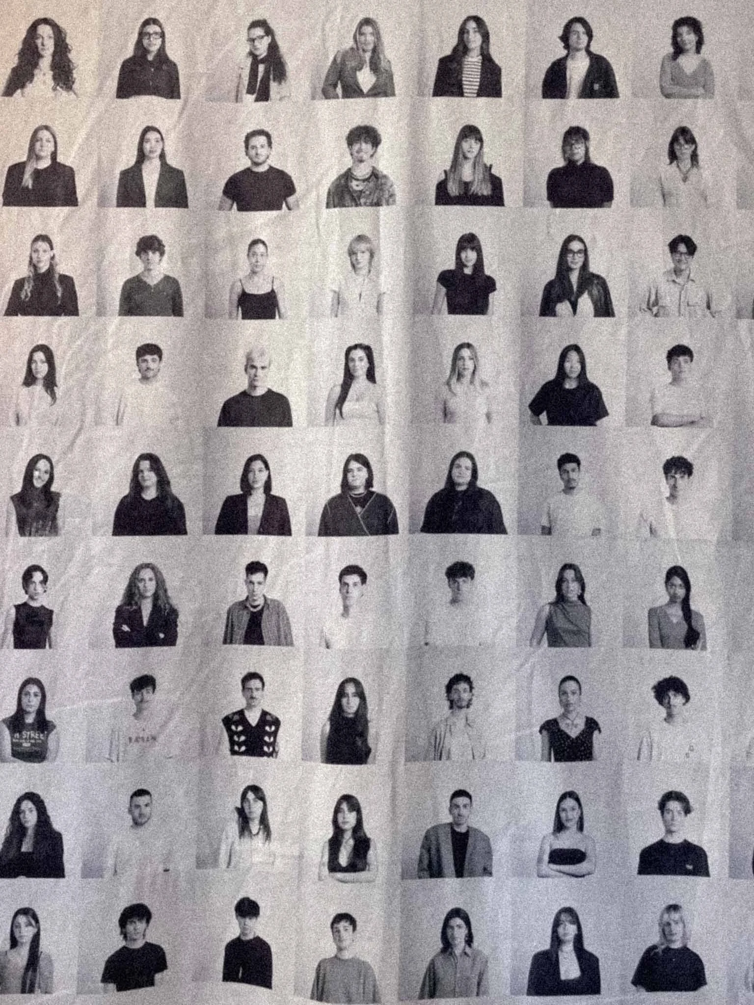A black-and-white photo of a large group of people arranged in rows, with individual portraits of diverse individuals, including men and women, with various hairstyles and clothing styles, likely from a magazine or yearbook.