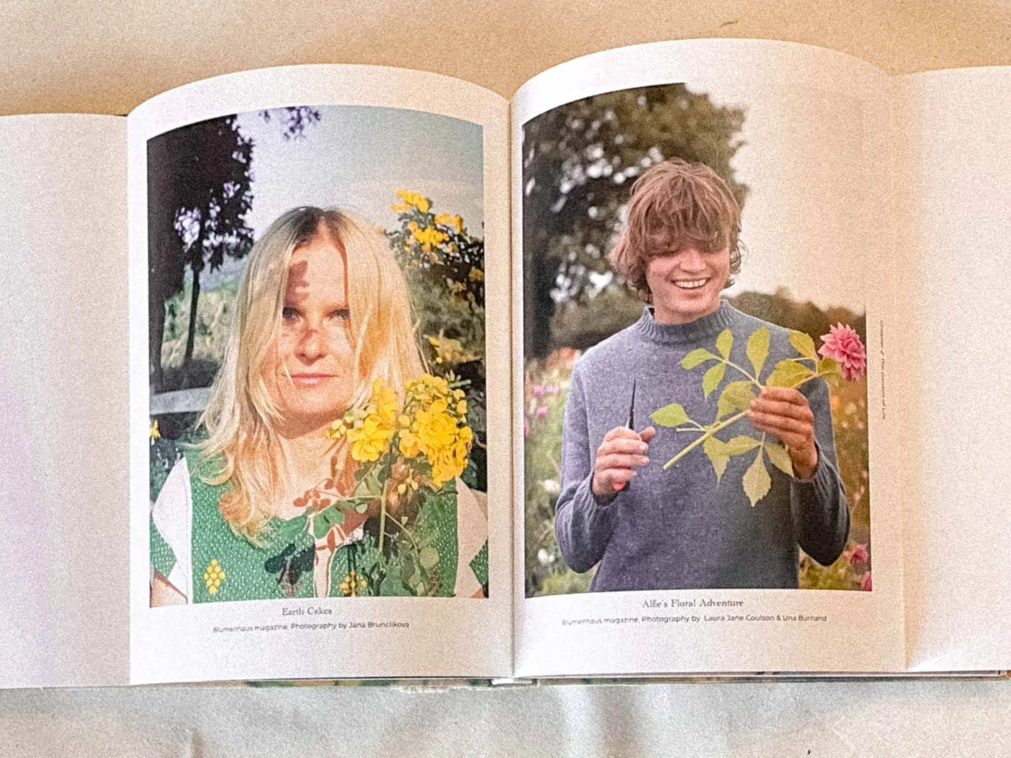 Open magazine showing two pages with photographs. The left page features a young woman with long blonde hair holding a bouquet of yellow flowers, outdoors with trees in the background. The right page shows a young person with curly hair smiling and h