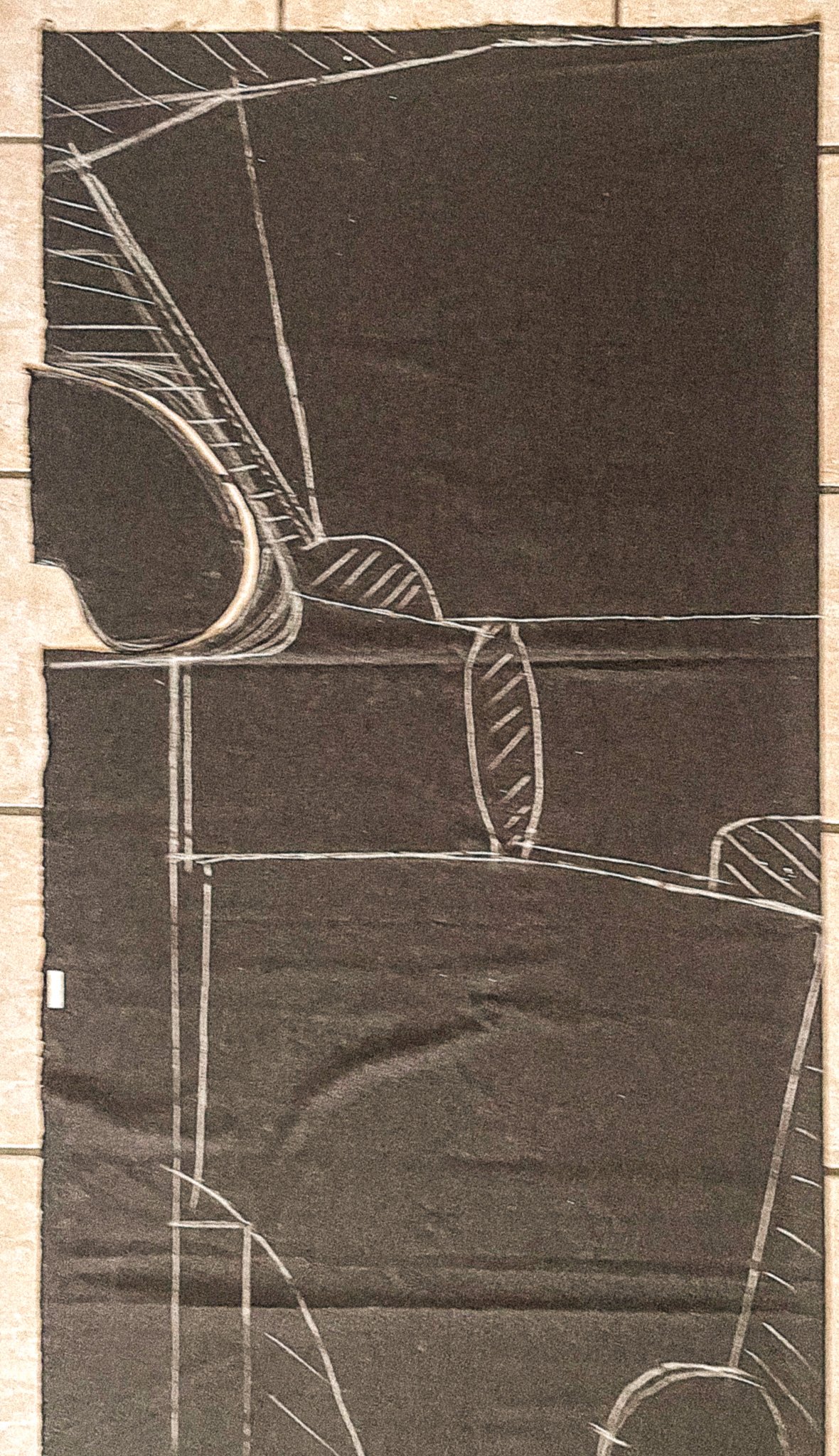 A chalk drawing on a blackboard depicting various geometric shapes and lines, including circles, ovals, and straight lines interconnected.