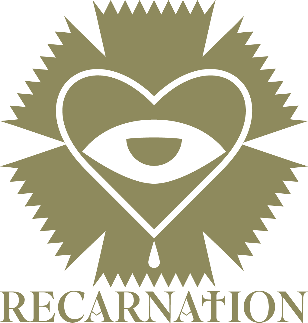 Stylized logo with a heart, an eye in the center, and an arrow underneath, surrounded by spiked shapes, with the word 'RECARNAION' below.