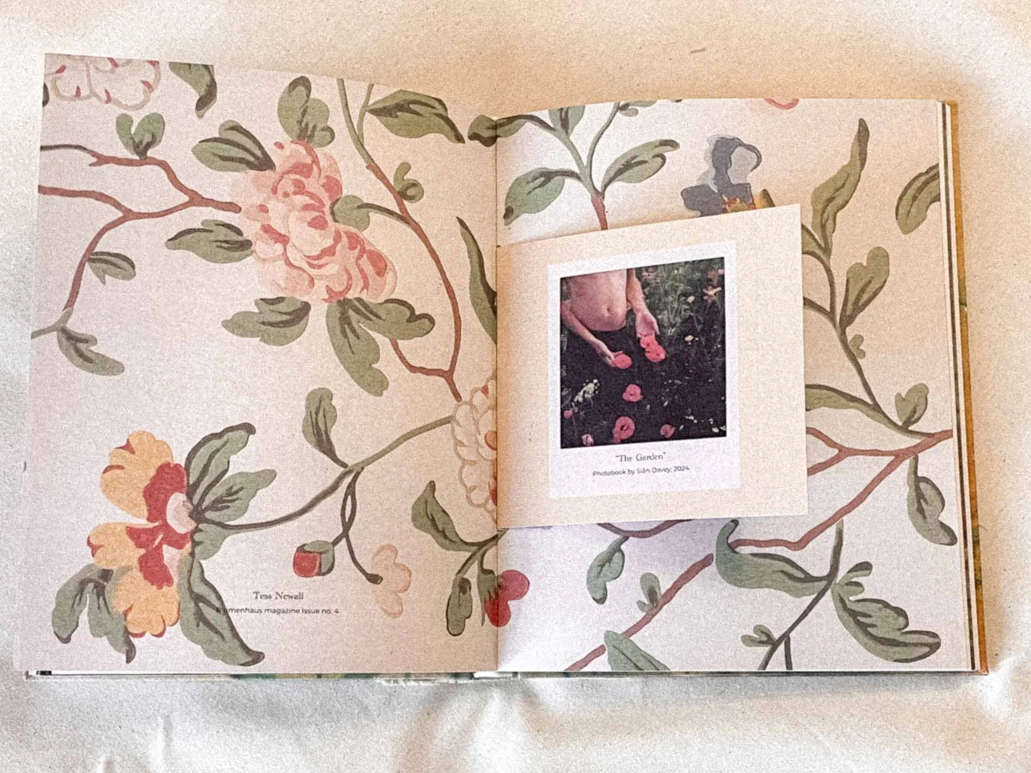 An open floral patterned book displaying two pages with images and text, with a photograph of a person in a garden on the right page and floral illustrations on the left page.