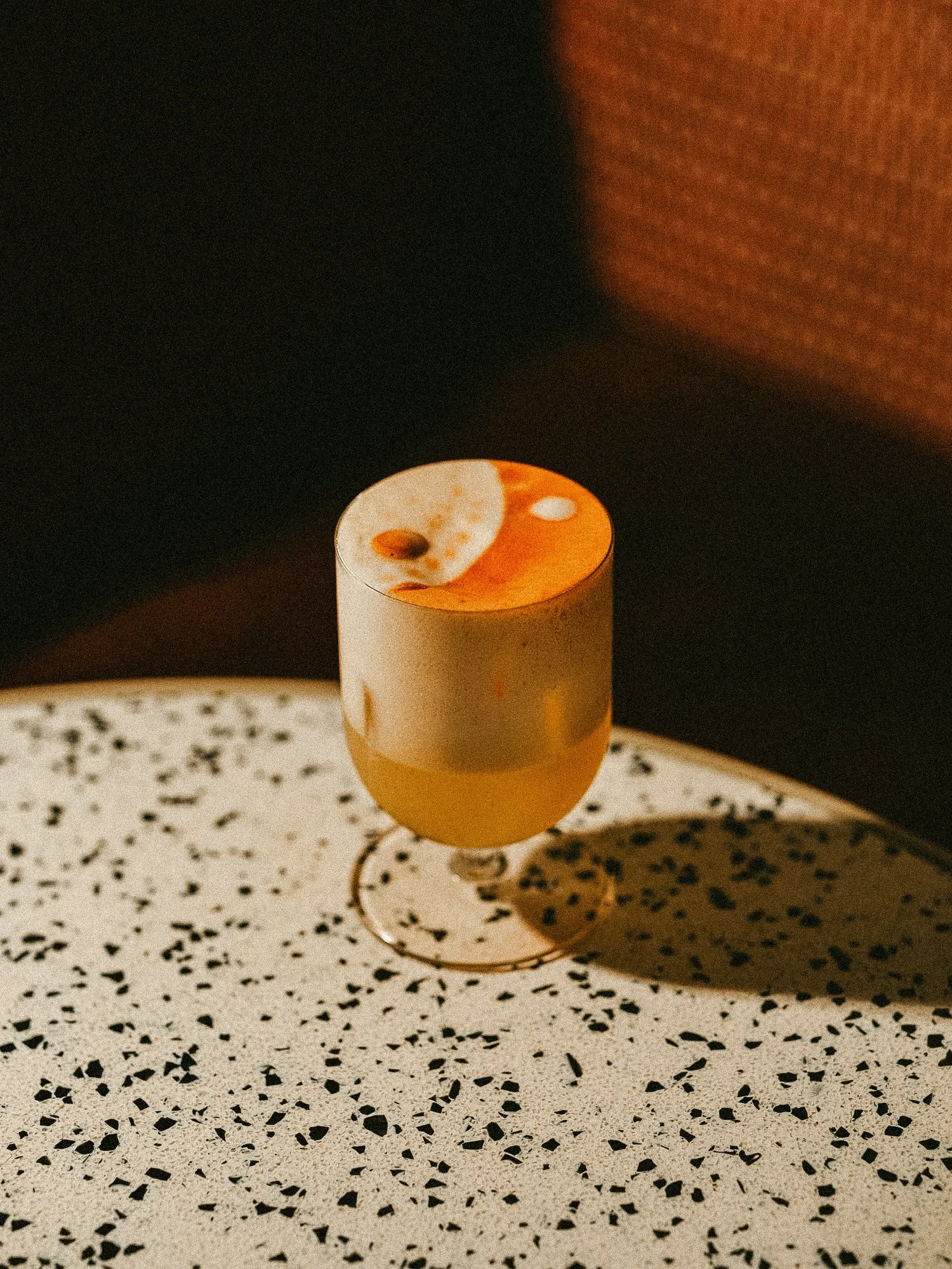 Sip cocktails at a bar on Manhattan Ave