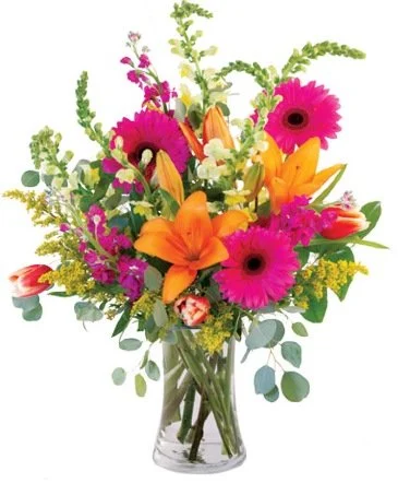 Colorful bouquet of pink, orange, and yellow flowers in a clear glass vase.