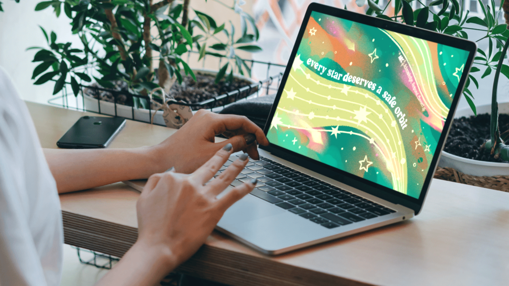 ARC illustrated desktop wallpaper on a laptop