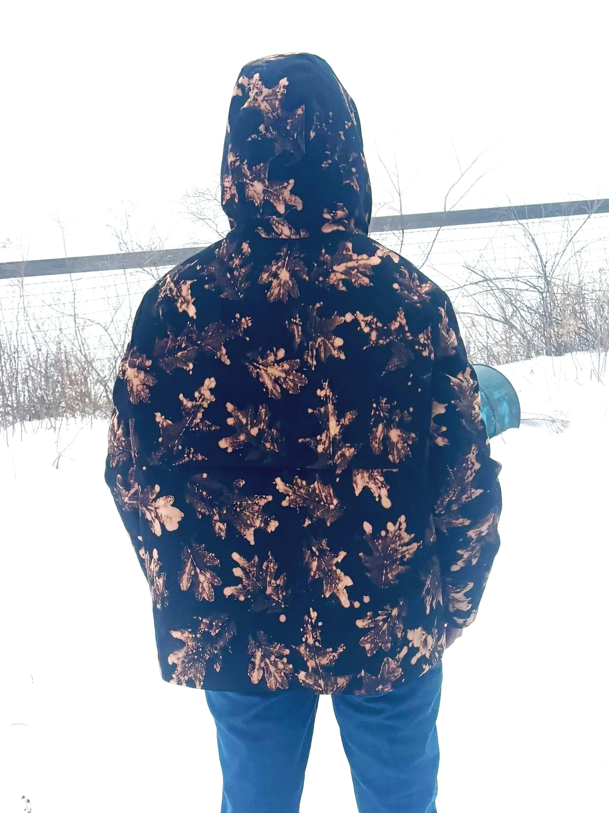 model wears the friday jacket by autofiction in black cotton canvas with bleach printed leaves and quilted lining size m