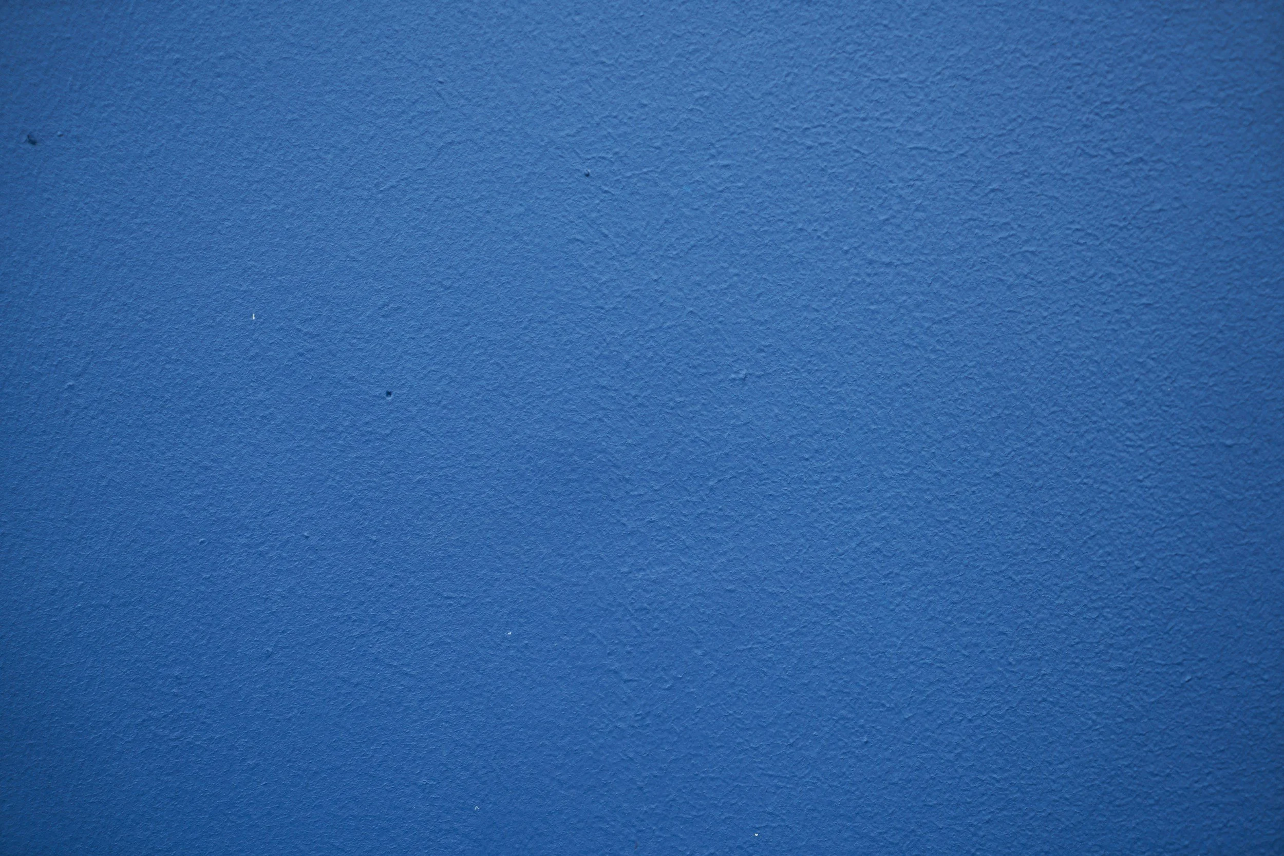 A close-up of a textured blue wall.