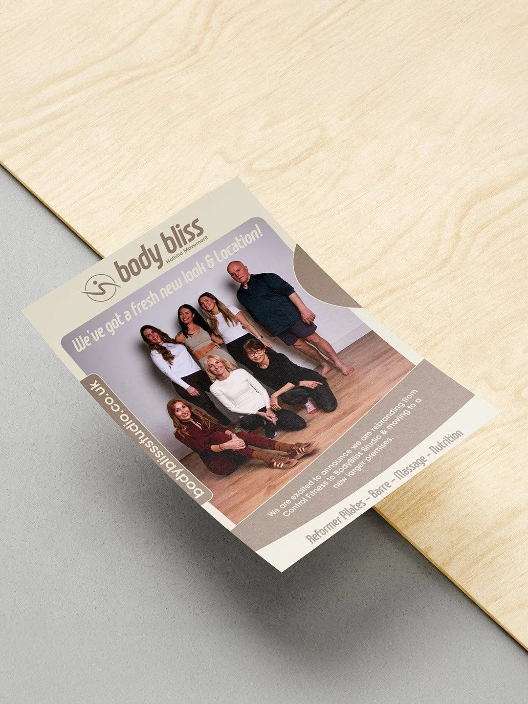 Flyer for Body Bliss Holistic Movement with a group photo of seven people in a fitness studio
