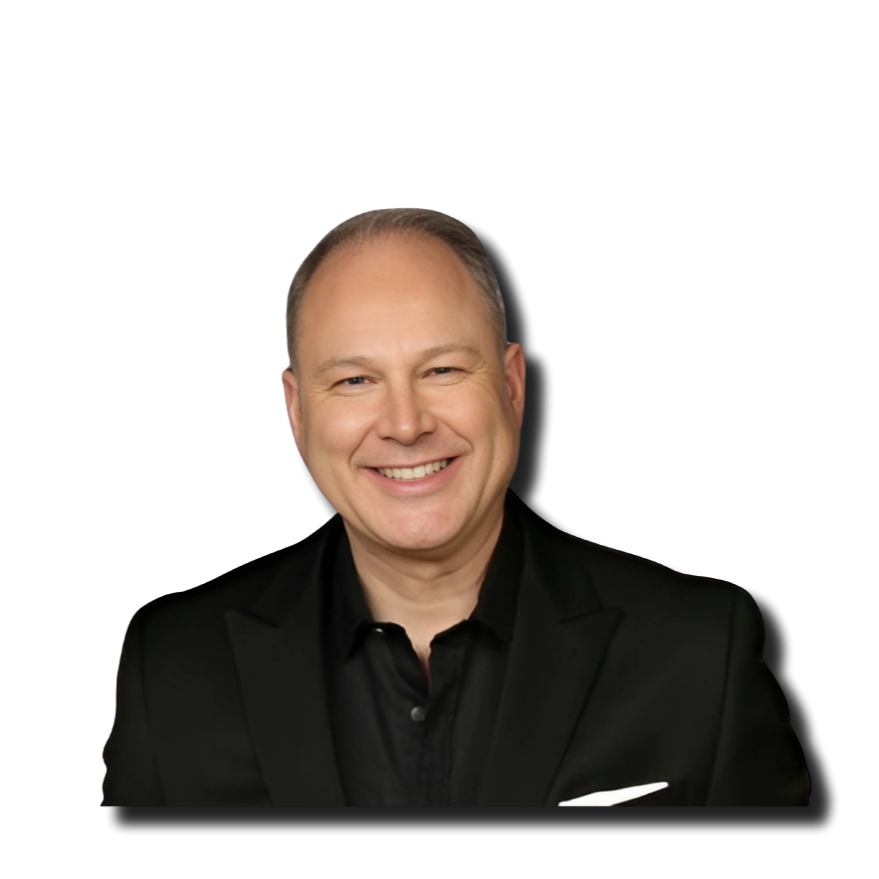 A smiling middle-aged man with short hair wearing a black suit jacket and black shirt, against a black background.
