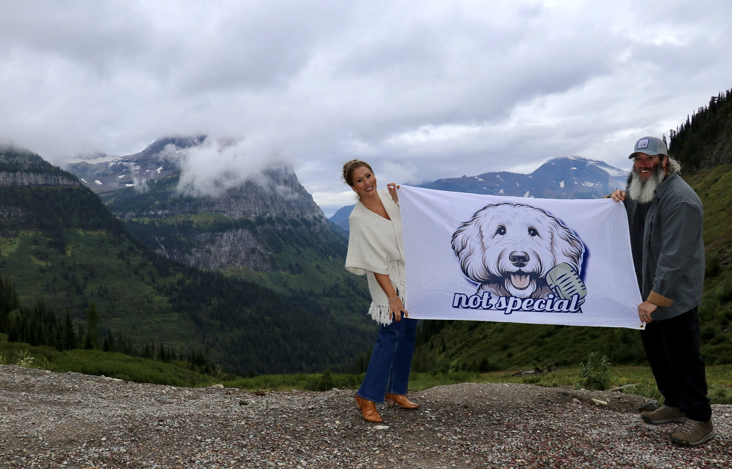 Corrie and Herb holding a Not Special flag in Glacier National Park