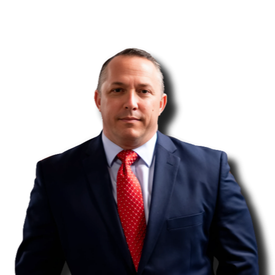 Professional man in a navy suit with a red patterned tie posing against a black background.