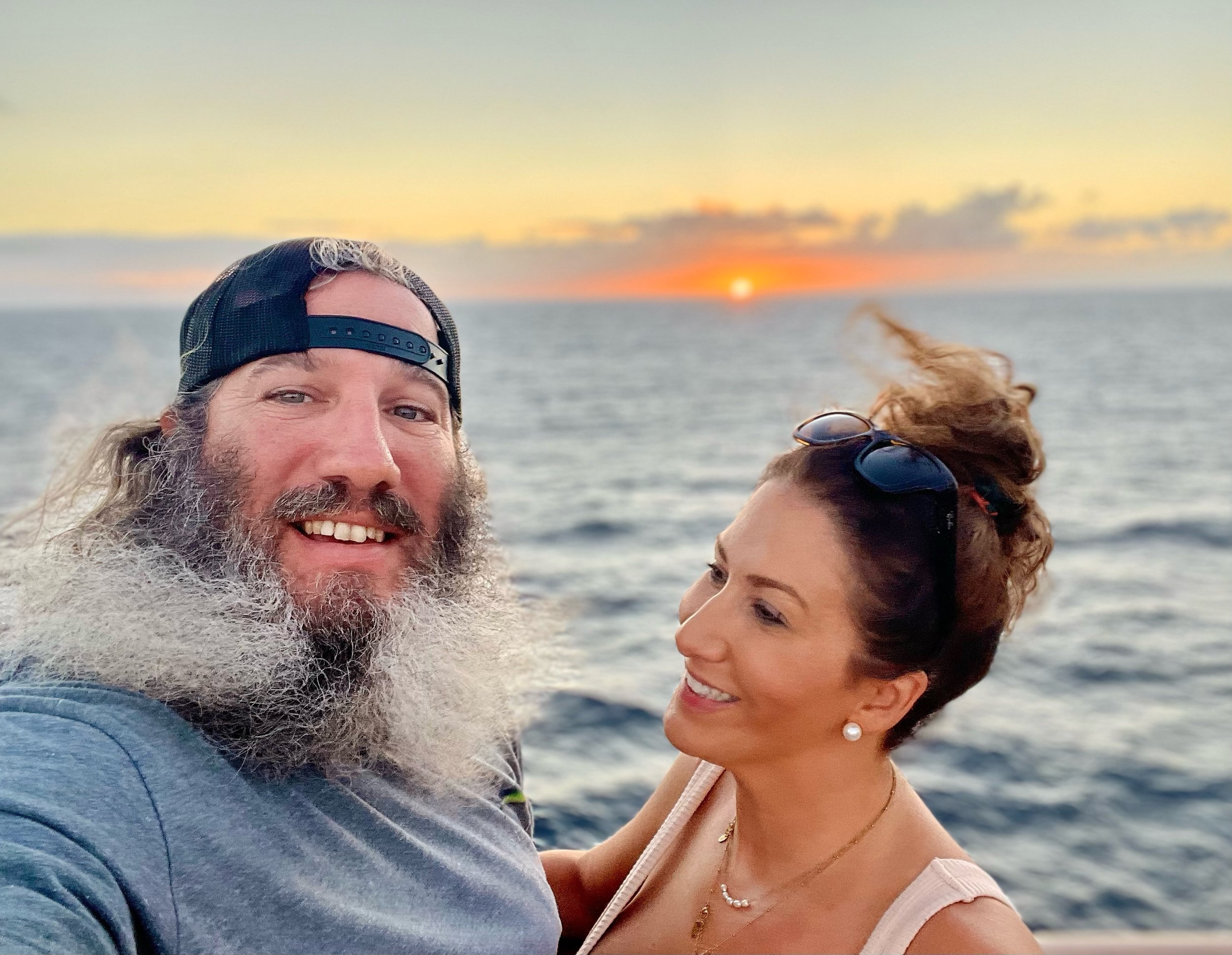 Herb and Corrie Thompson with a sunset over the ocean in the background