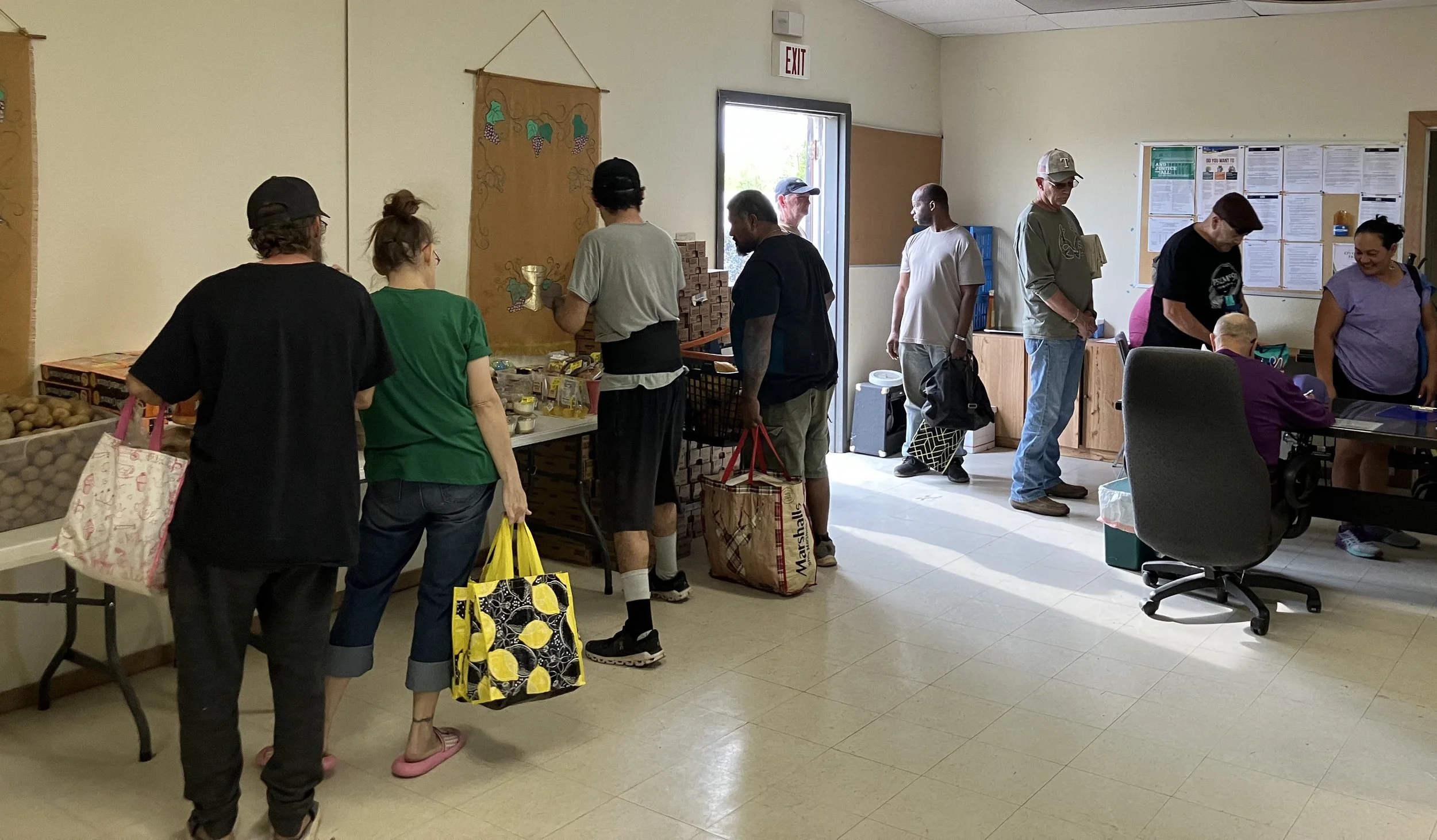 People in line picking up food items