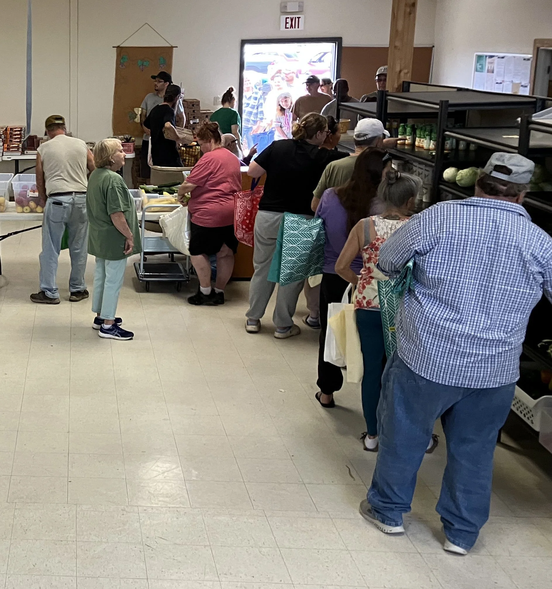 People in line picking up food items