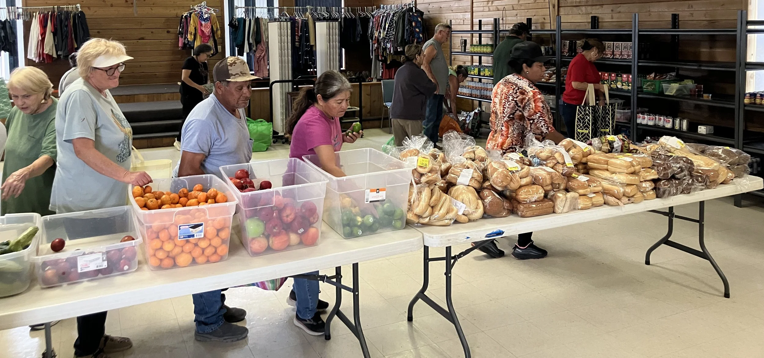 People in line picking up food items