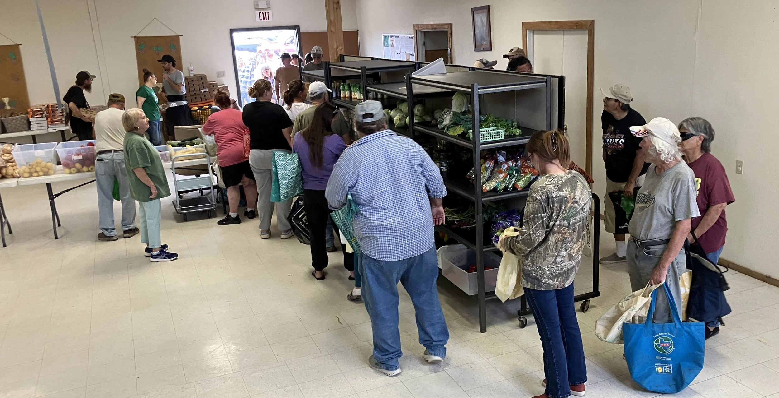 People in line picking up food items