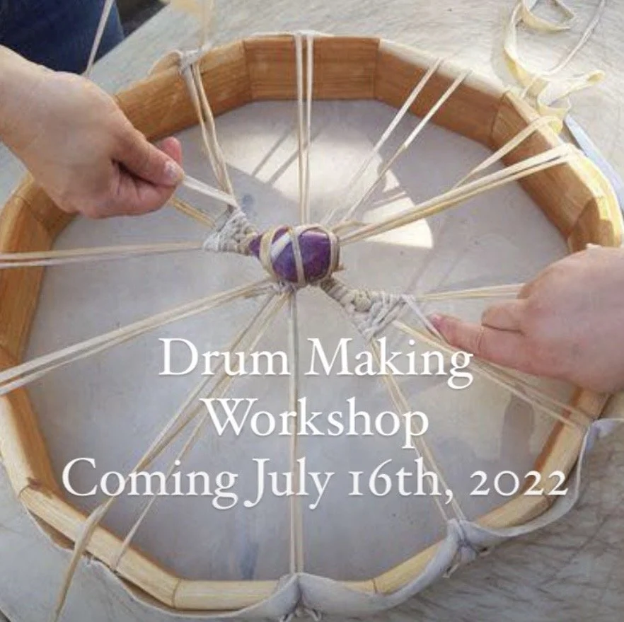 Close-up of a drum, showing two hands tightening or adjusting the drum's strings or tension, with text overlay promoting a drum making workshop scheduled for July 16th, 2022.