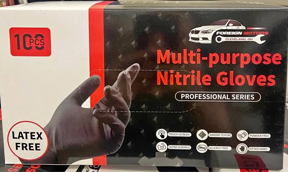 Box of 10 multi-purpose nitrile gloves with black glove on hand giving a thumbs up, labeled latex free, powder free, ultra durable, allergy free, fitted hand, with icons for touch screen, diamond texture, powder free, latex free, allergy free, and fitted hand.