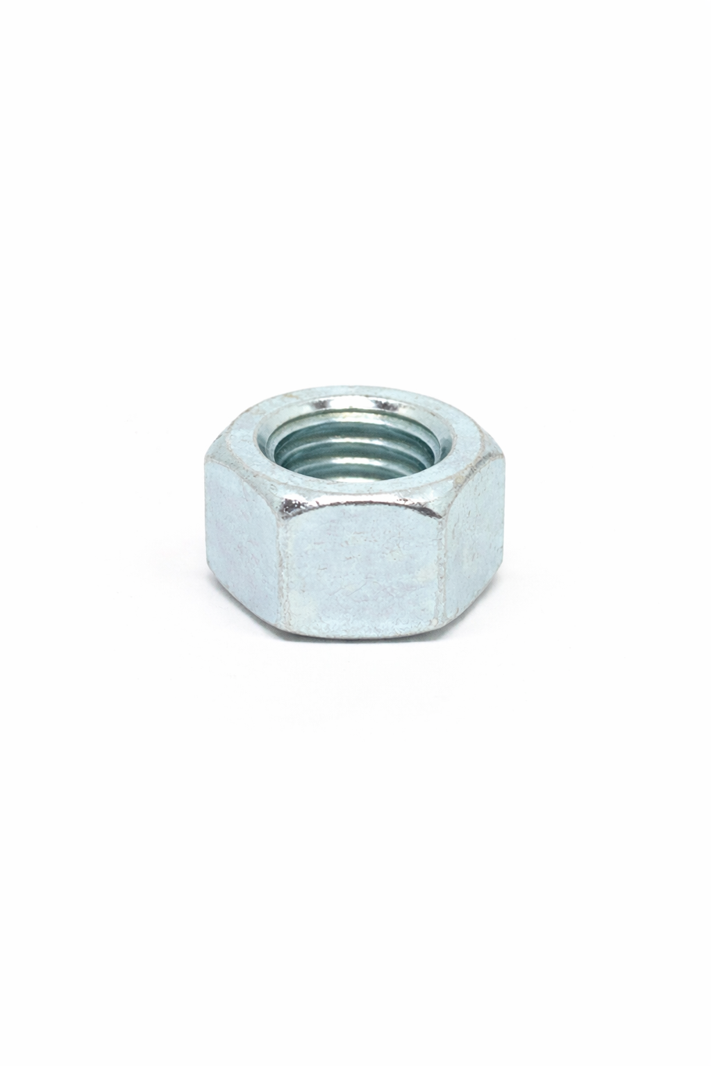 Close-up of a metallic nut on a white background.