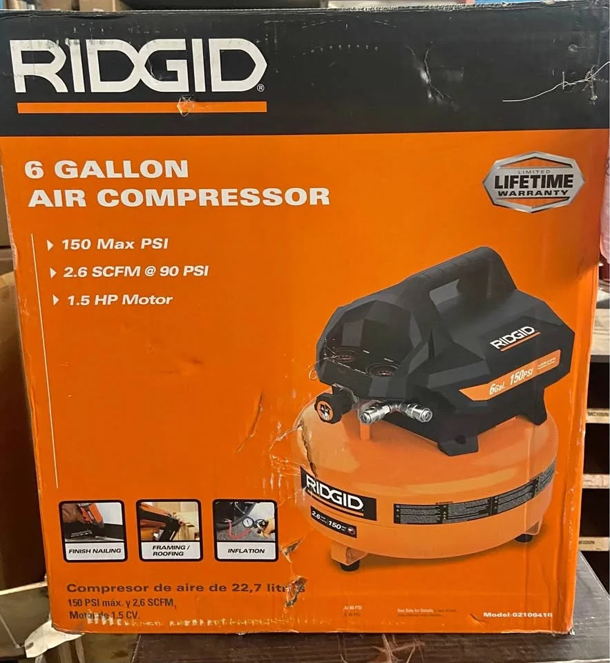 Product packaging for a RIDGID 6-gallon air compressor with a 1.5 horsepower motor, 150 PSI maximum pressure, and 2.6 SCFM at 90 PSI, with a lifetime warranty