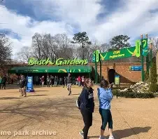 Entrance of Busch Gardens with visitors walking outside on a cloudy day.