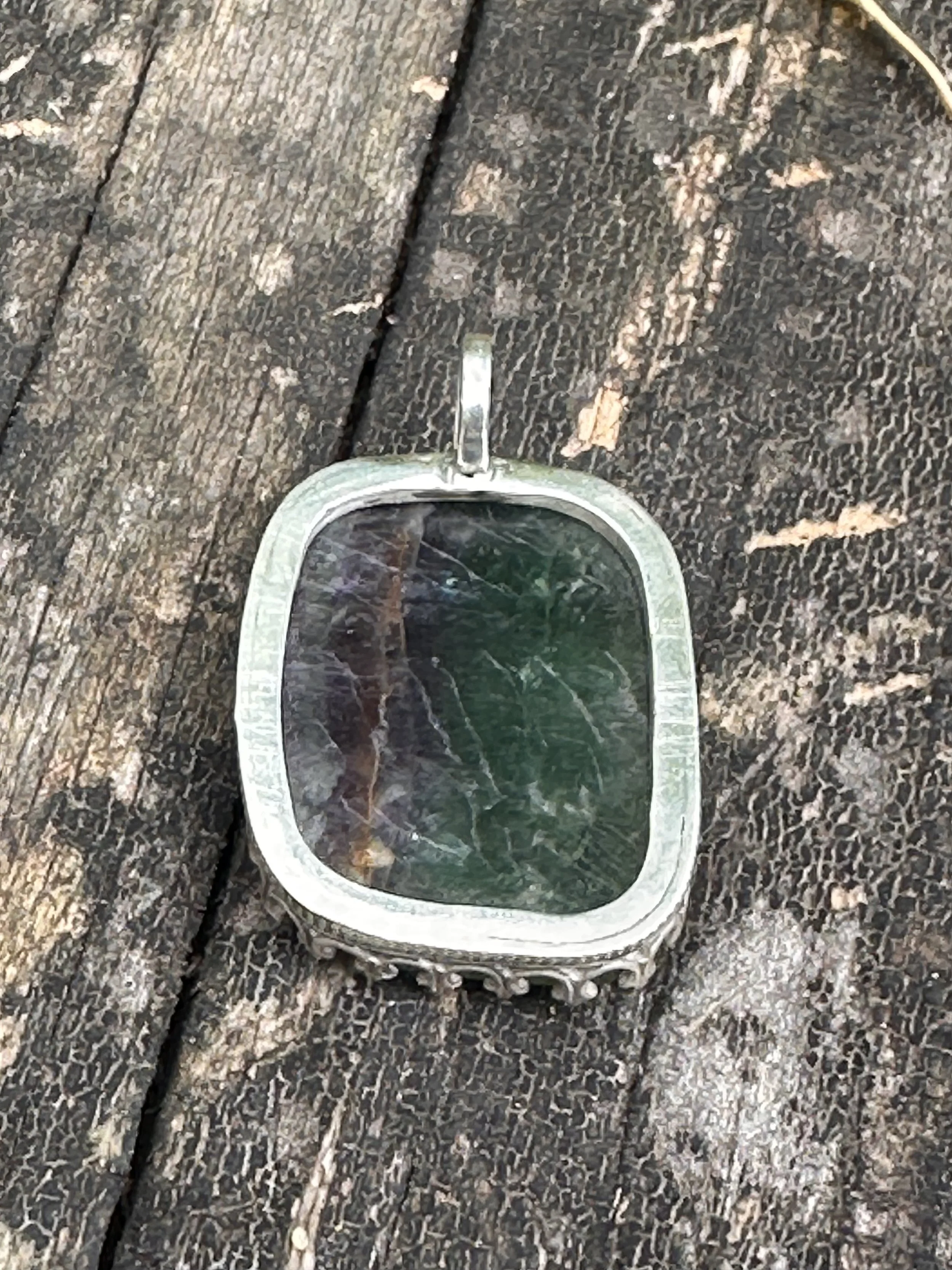 Back side of a fluorite open-back pendant