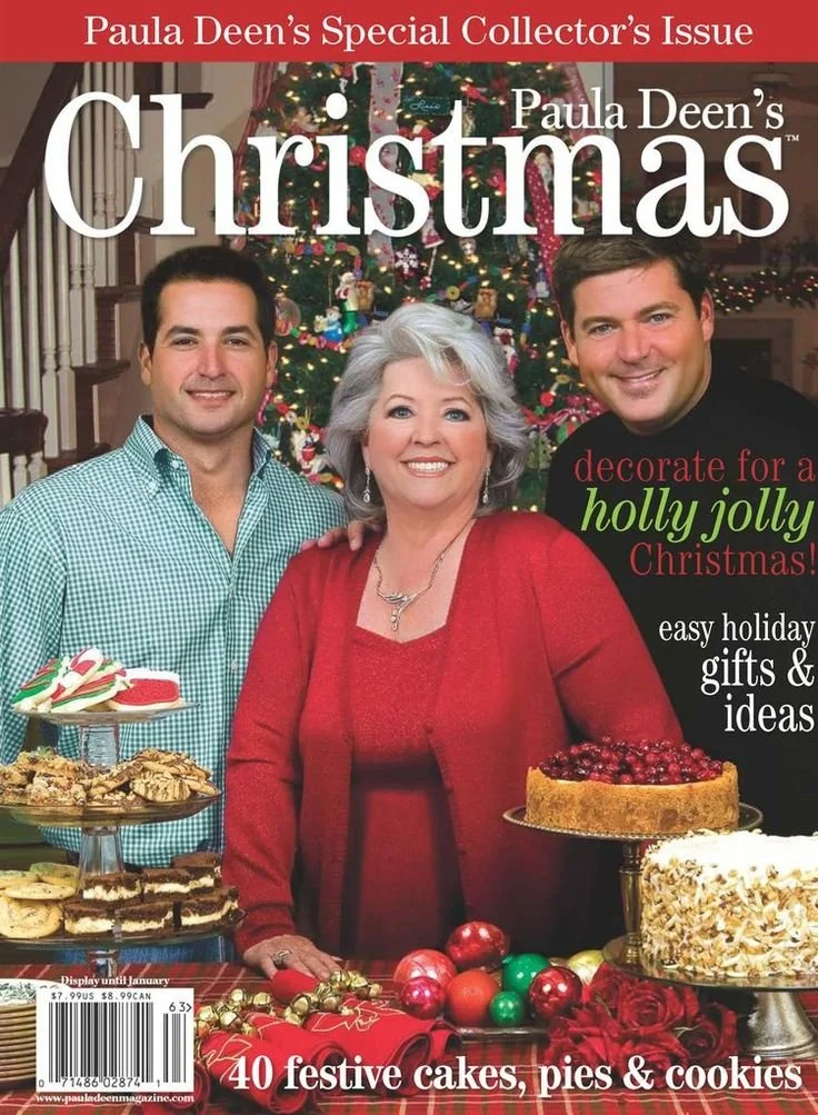 Magazine cover titled 'Paula Deen's Christmas' featuring Paula Deen and two men in front of a decorated Christmas tree, with holiday cakes, pies, and cookies on display.
