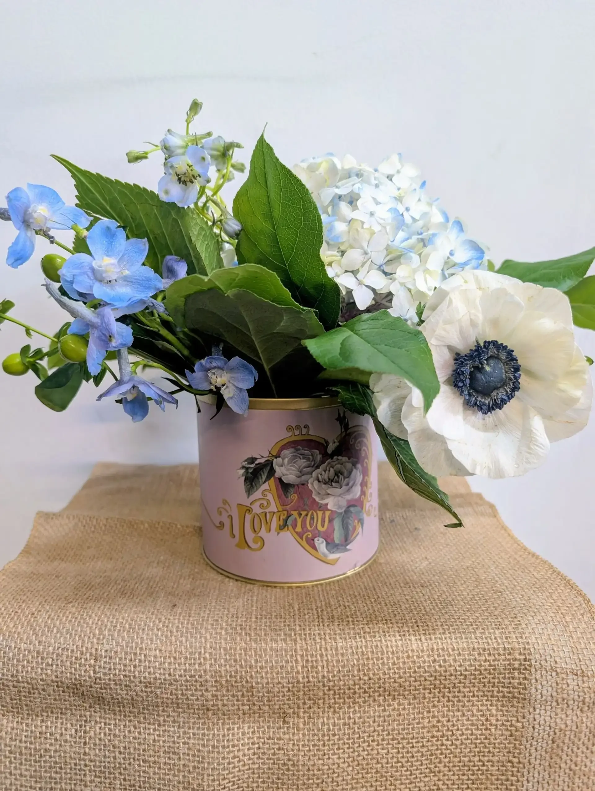 Fresh flowers in a keepsake tin.