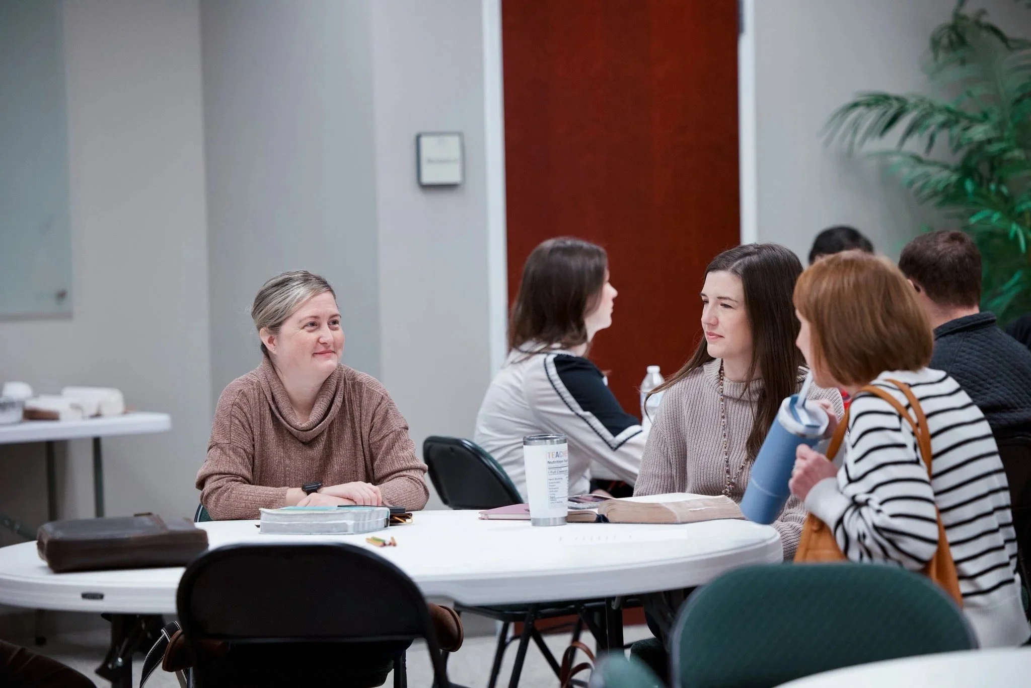 Women of Central Baptist talking and smiling around a table during Bible study
