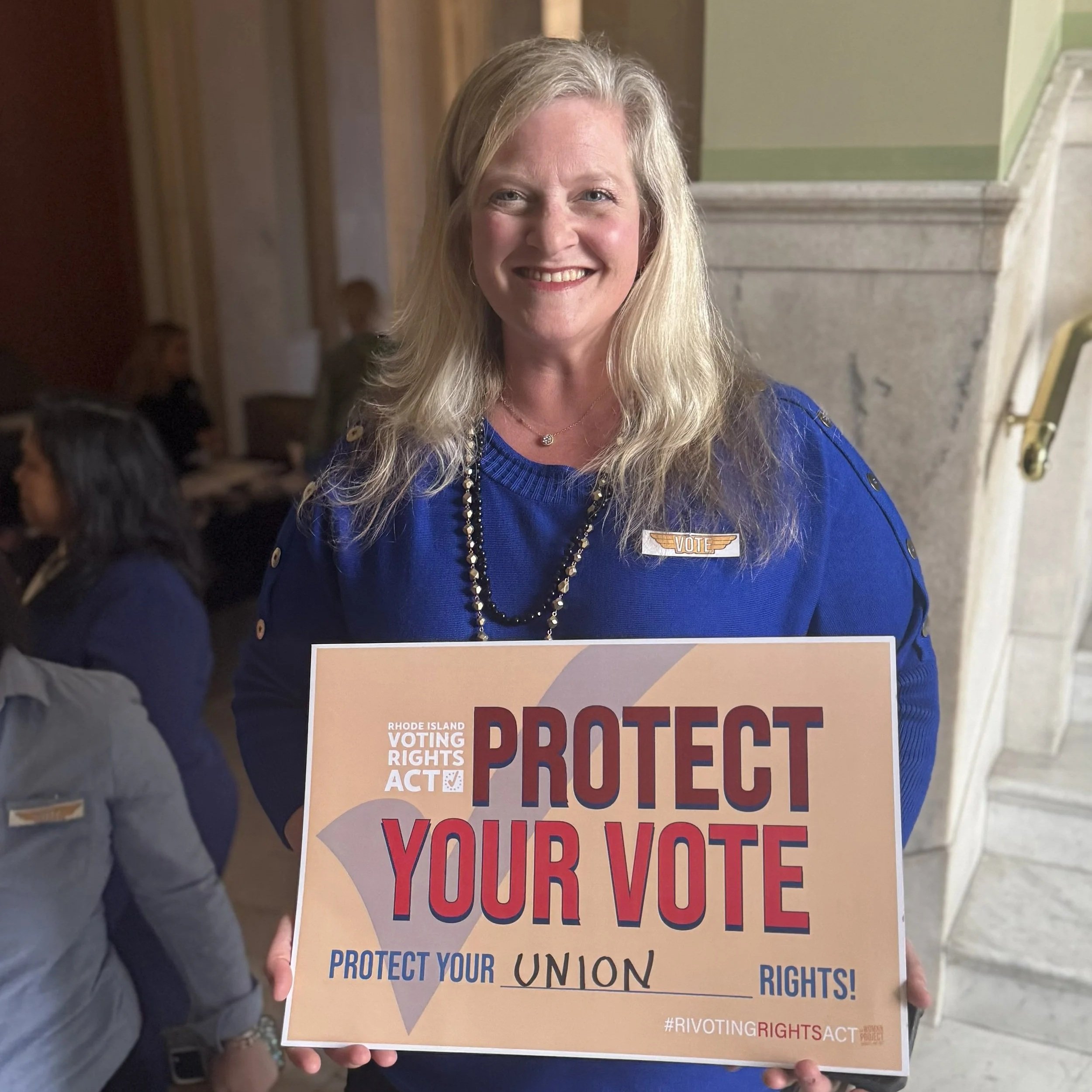 Supporter holds Protect Your Vote sign