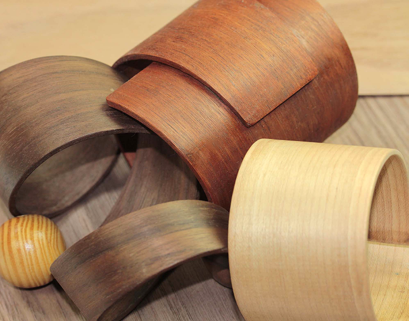 Various wooden rings and a small wooden ball on a wooden surface.