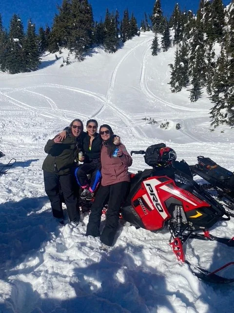 Women having fun and enjoying a day of snowmobiling. Photo by Alexandra Trenholm