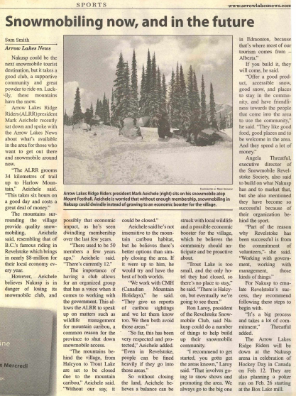 Snowmobilers riding through a snow-covered field with tall trees in the background, during winter daytime in Nakusp British Columbia
