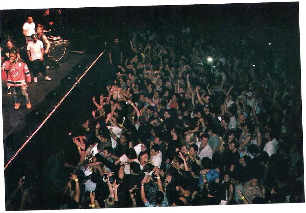 Crowd of people dancing and enjoying a concert on a stage with a DJ and performers. music, editorial, album cover, photoshoot, conceptual, concept art
