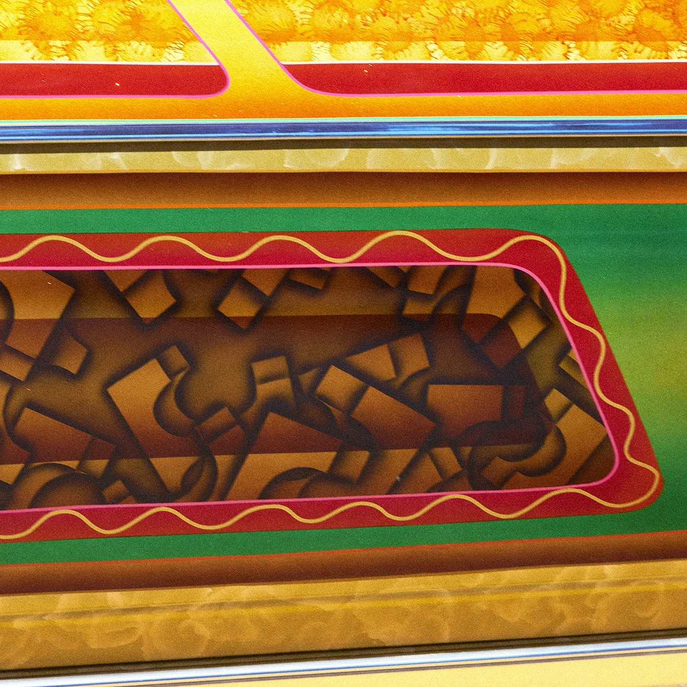 A colorful arcade game with a maze of black lines on an orange background, framed with red and green borders and yellow accents.