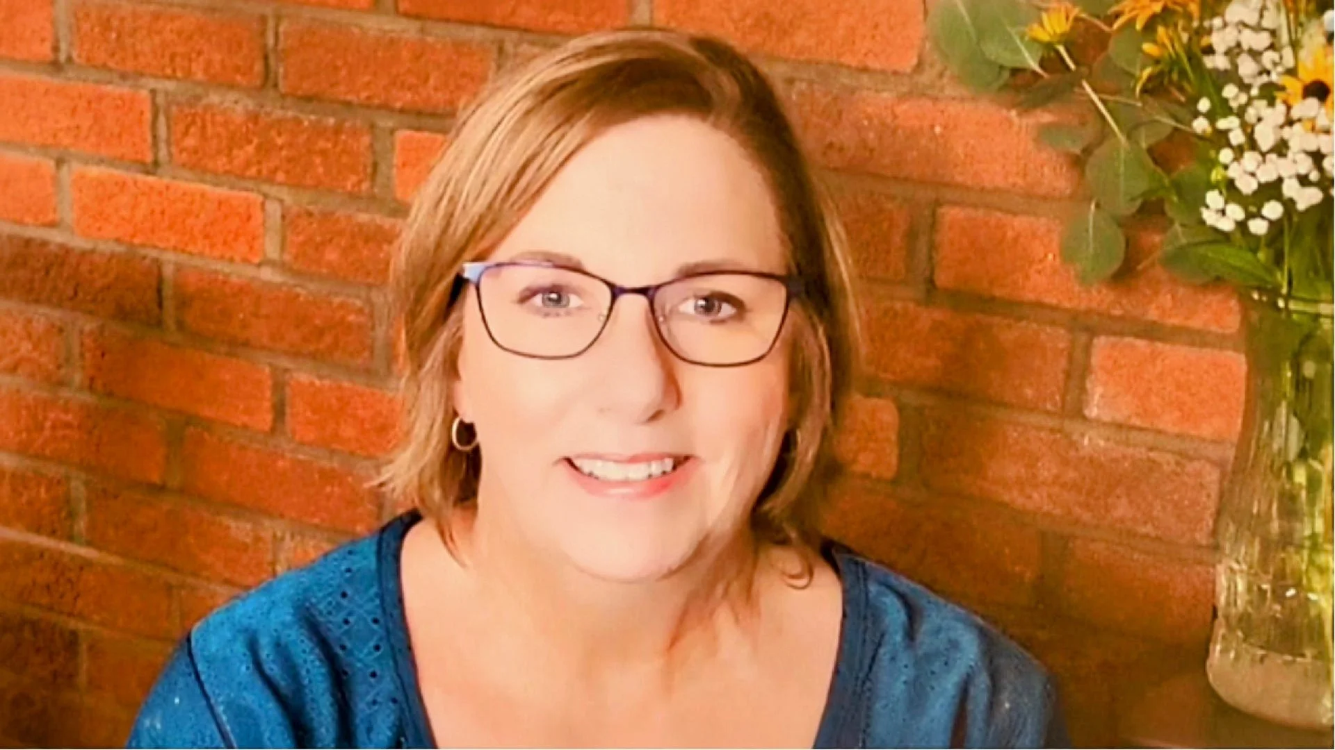 Kelly Bell, founder of IEP Decoded, smiling on a porch, video introduction on the home page