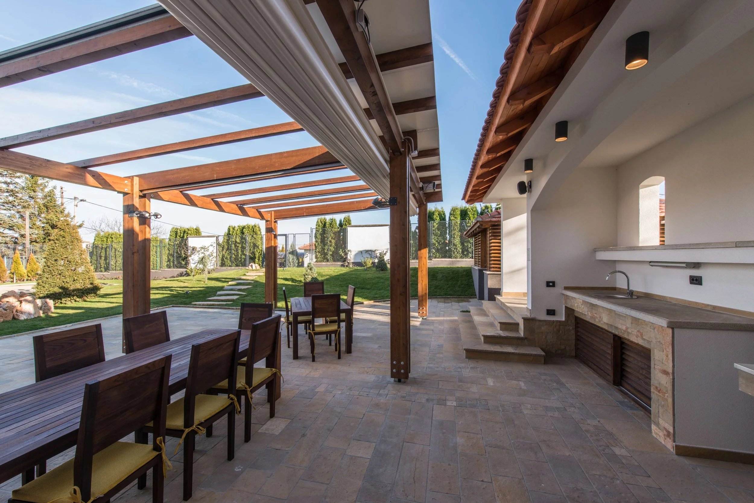 Custom outdoor kitchen with pergola and dining area in Lynchburg, VA.jpeg
