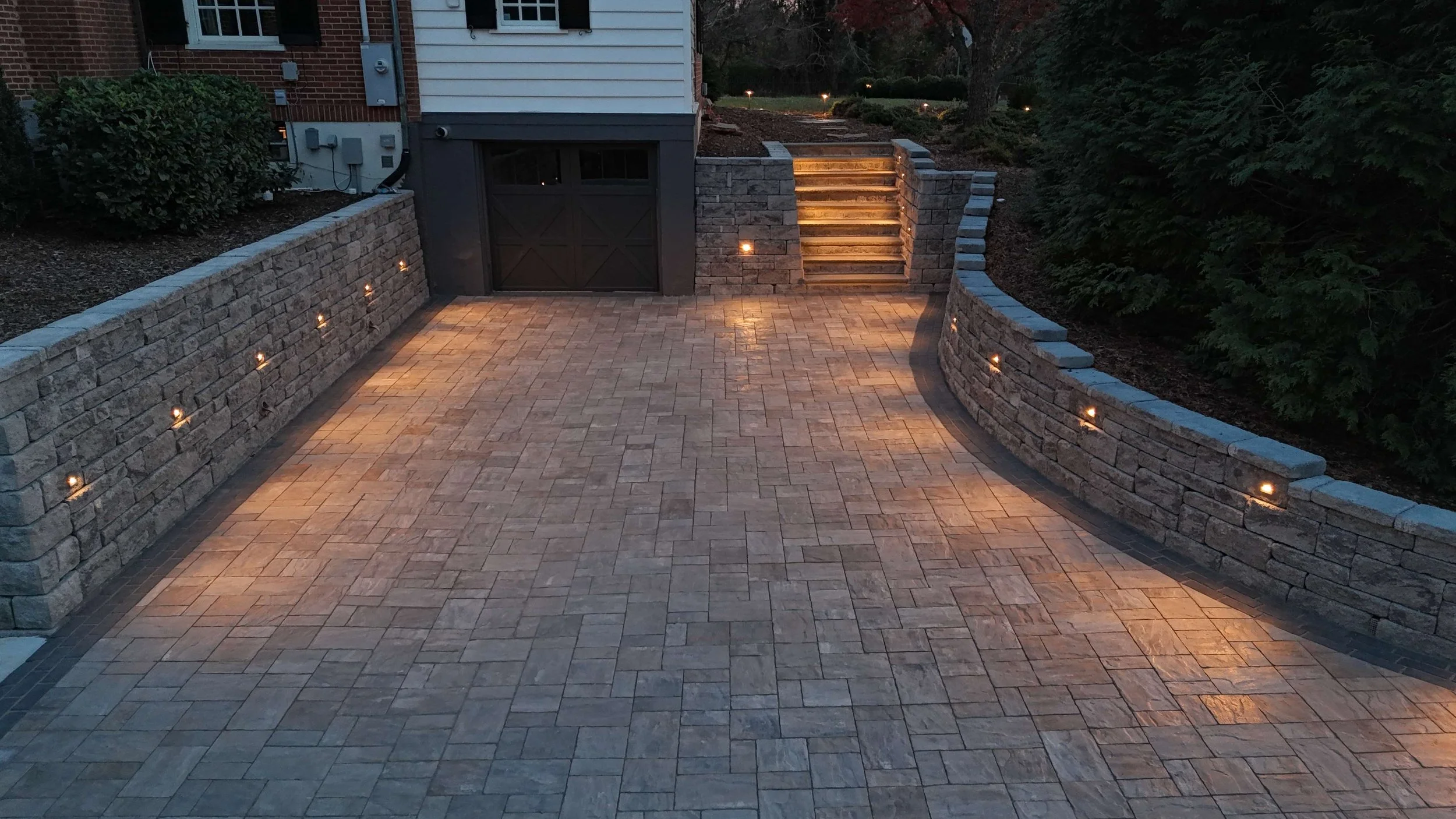 Paver driveway with retaining walls and step lighting in Bedford, VA hardscape design and installation.jpeg