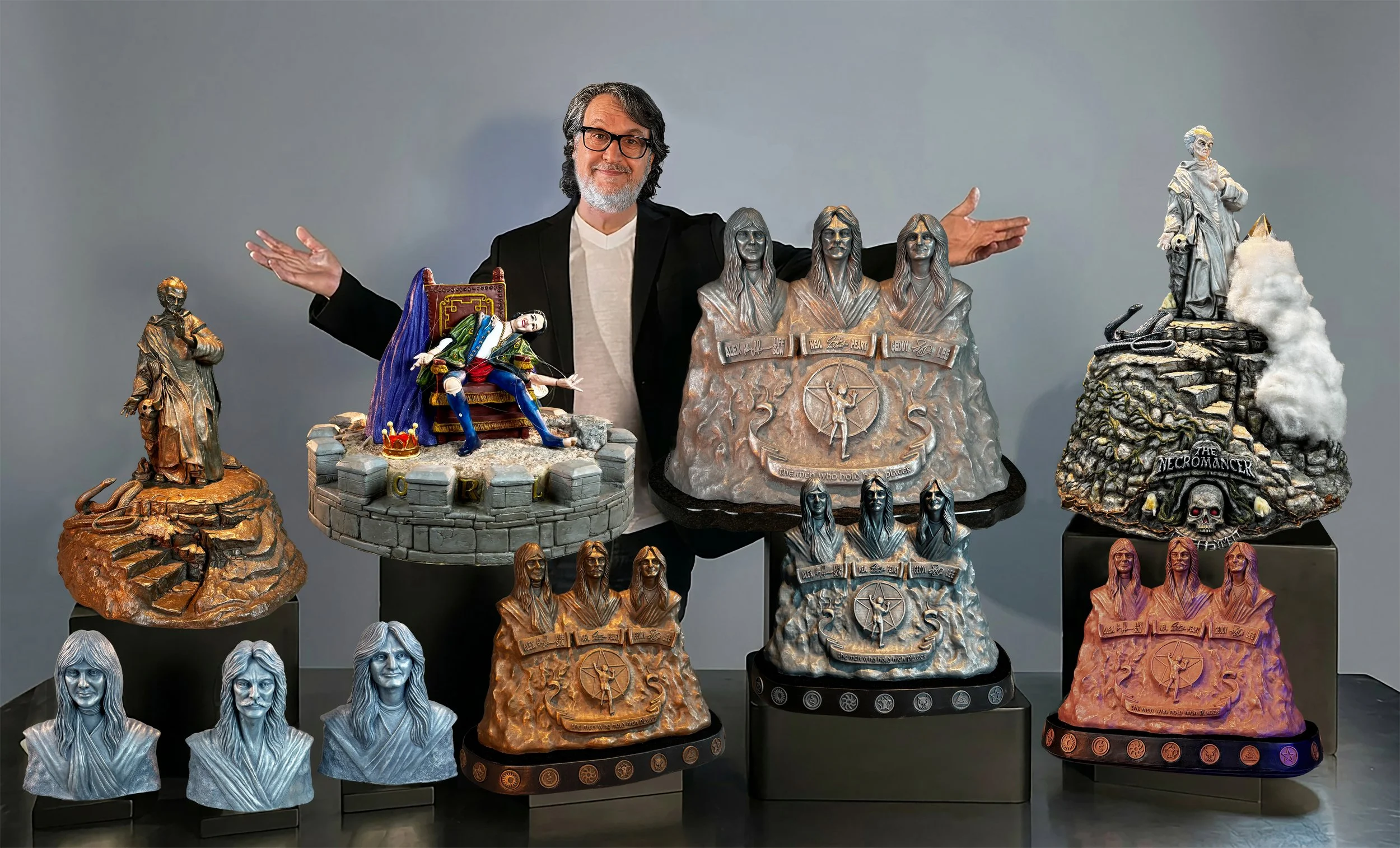 Collection of detailed Rush inspired sculptures featuring characters and scenes from from Rush's catalog of music, arranged on black platforms against a plain gray background.