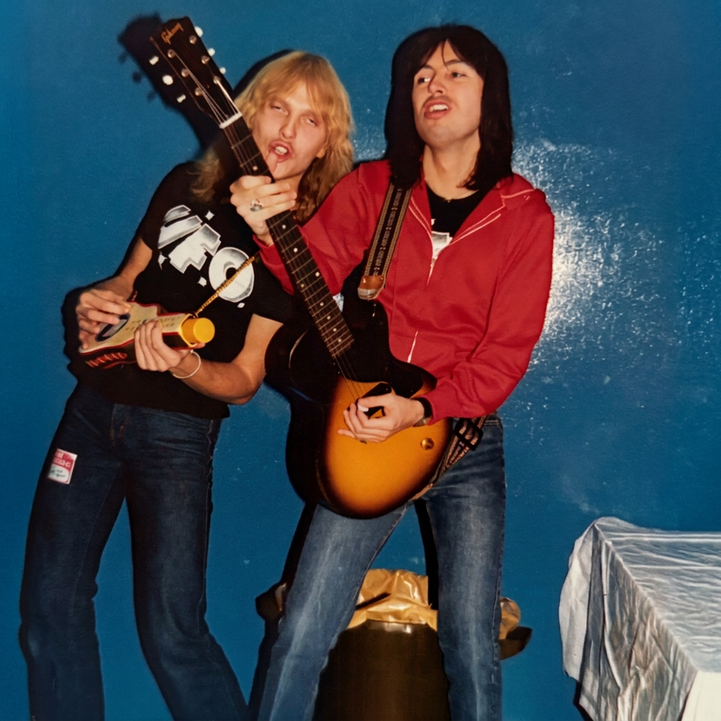 Michael Schenker hamming it up backstage with Paul Raymond following the Rush Concert at Erie County Field House, Erie PA 11/27/1977 (Note: Not my photo: This was given to me by a photographer who’s punk band pseudonym was Elliot Goldstein  If you ar