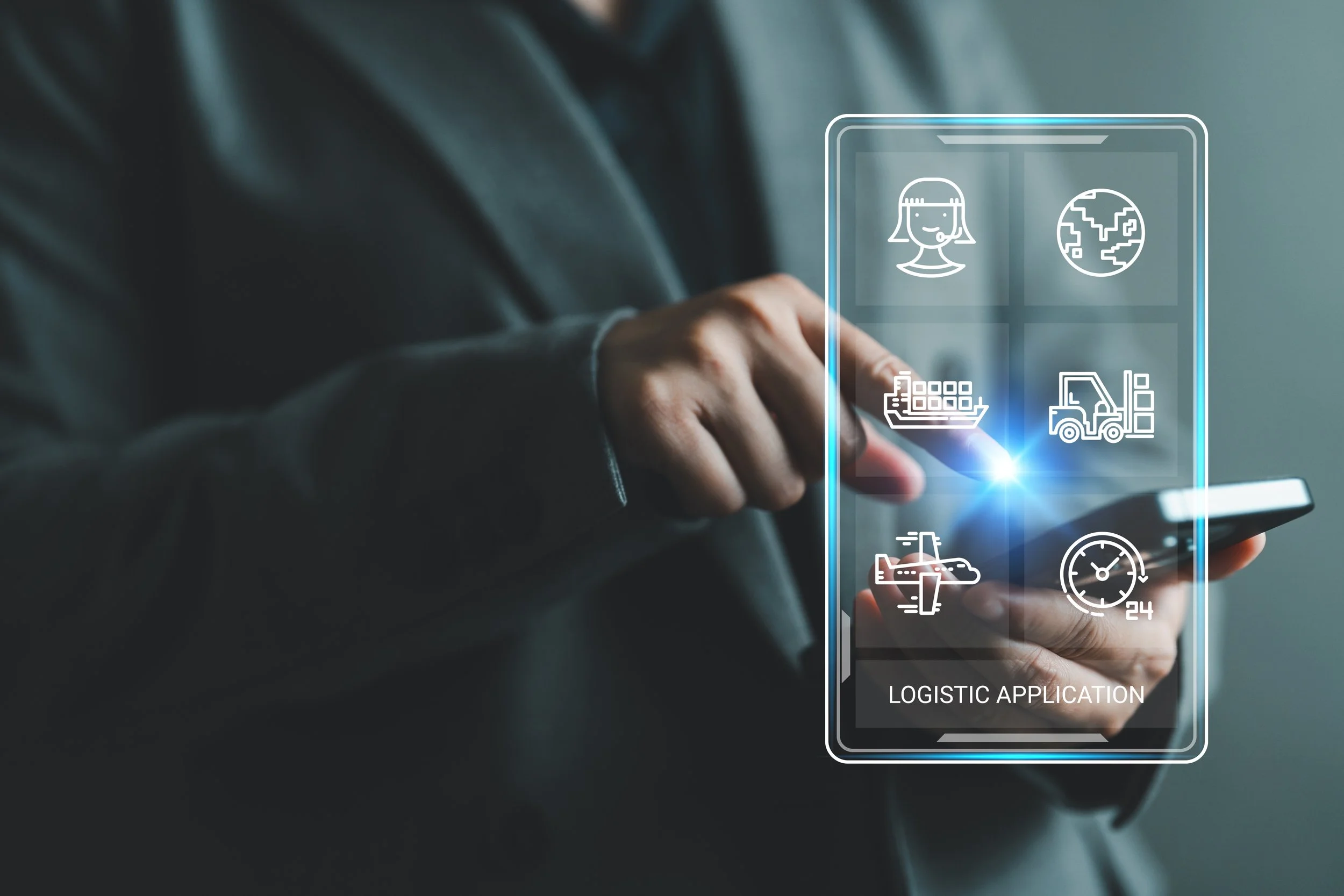 Person interacting with a transparent digital screen displaying icons including a woman, globe, cargo ship, forklift, airplane, clock, and the words 'LOGISTIC APPLICATION'.