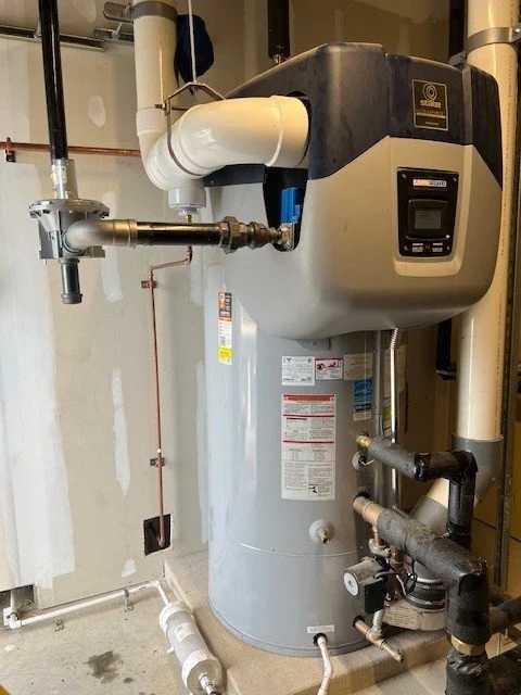 A water heater or boiler installed in a utility room with various pipes connected to it.