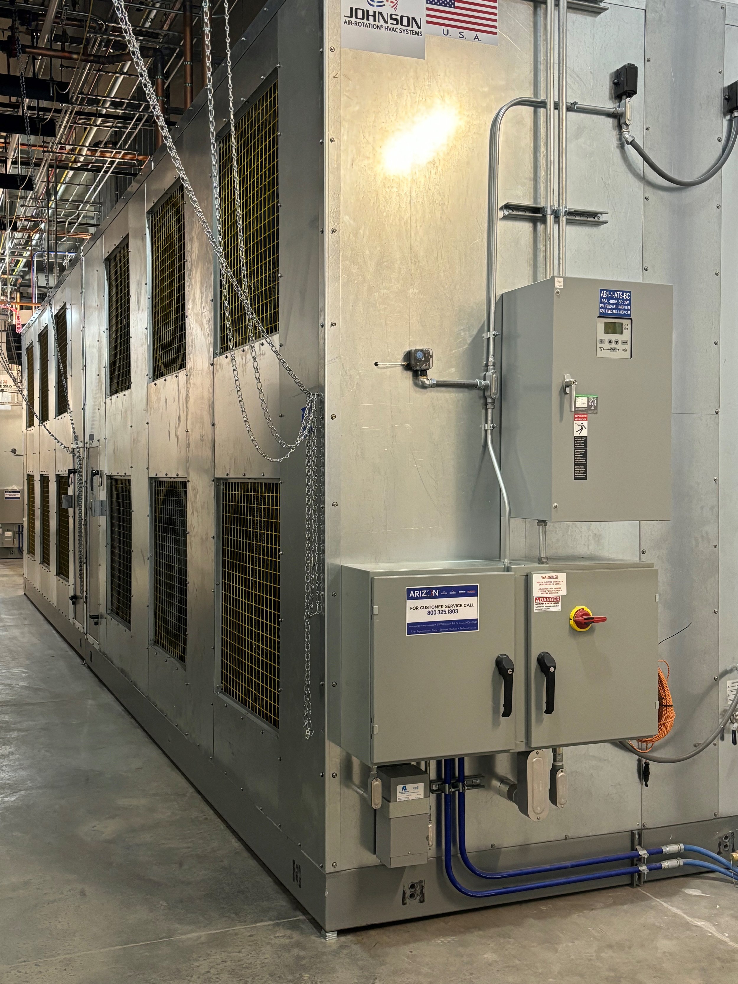 Integrated electrical control panel and power distribution for a DataCool fan coil wall installation.