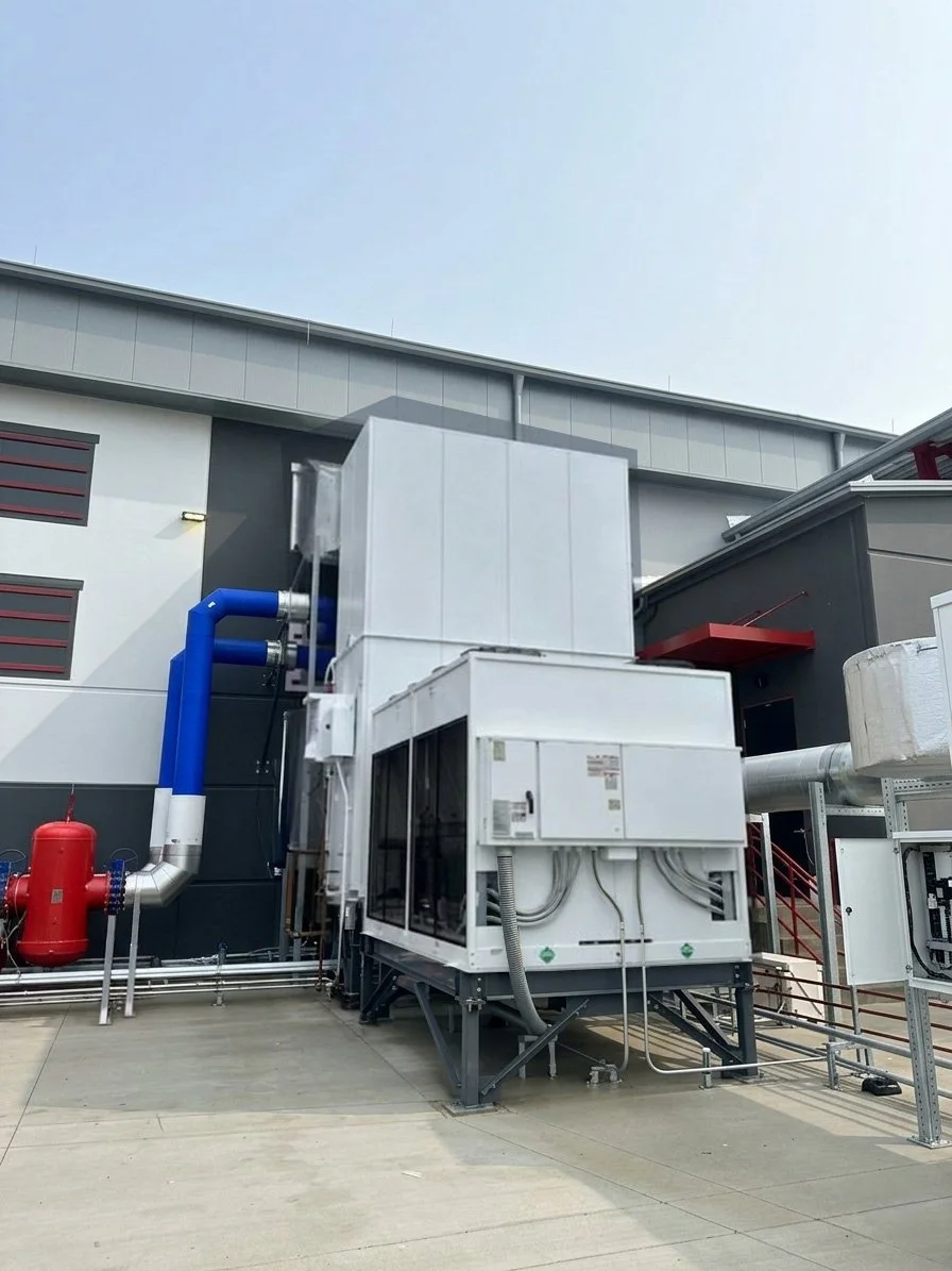 Industrial HVAC equipment with coils and pipes outside a critical environment