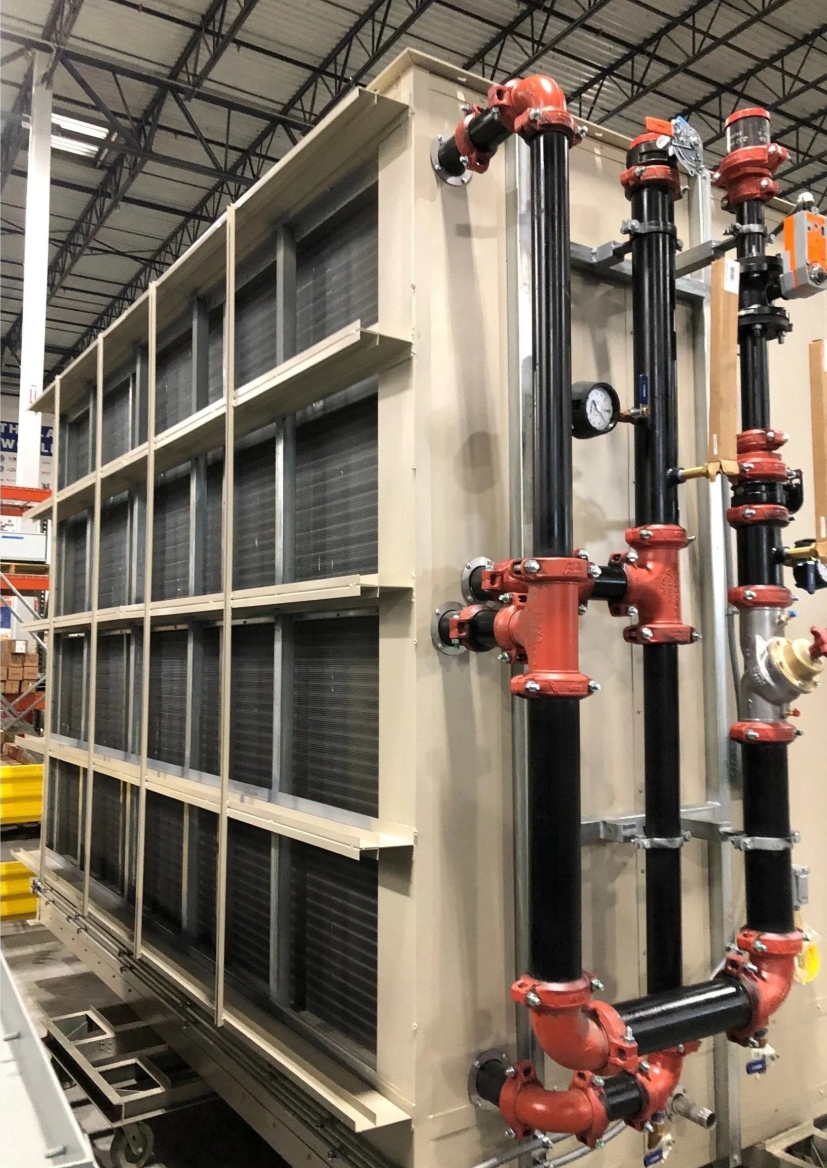 Factory-installed configurable piping package with chilled water supply and return connections for data center cooling.
